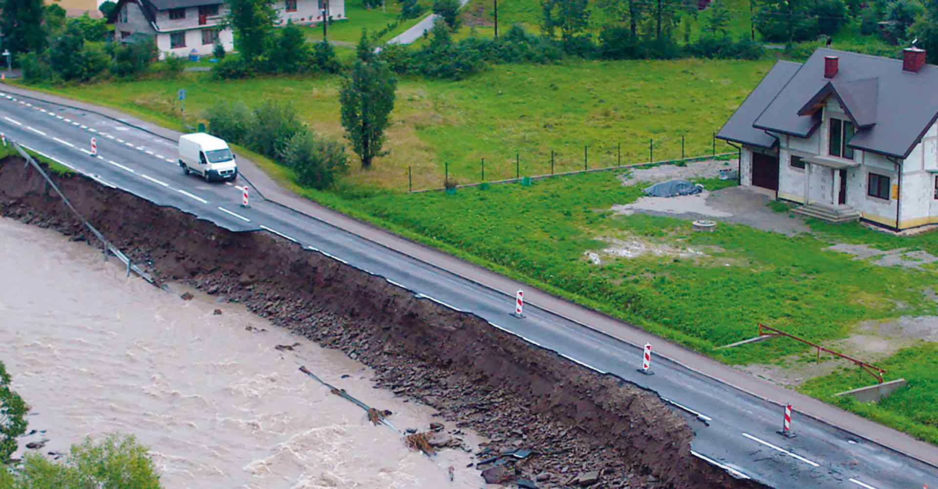 van driving along a crumbling road